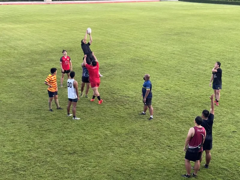 A rugby lineout drill on the grass pitch