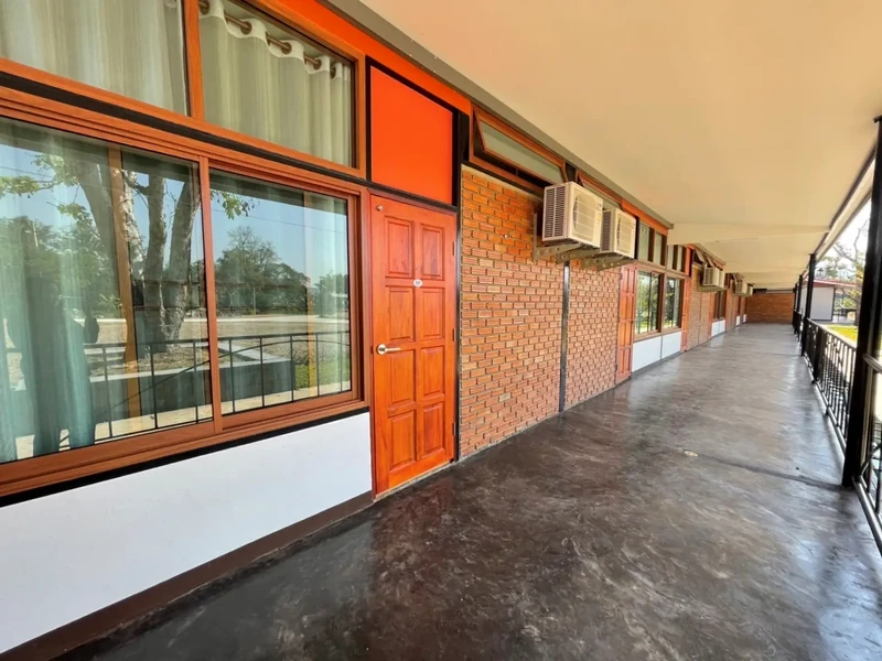 The covered walkway outside the guest rooms, looking out to the pitch